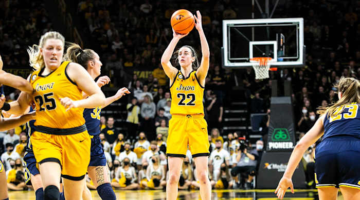 Caitlin Clark makes a 3-point basket during a NCAA Big Ten Conference women’s basketball game against Michigan